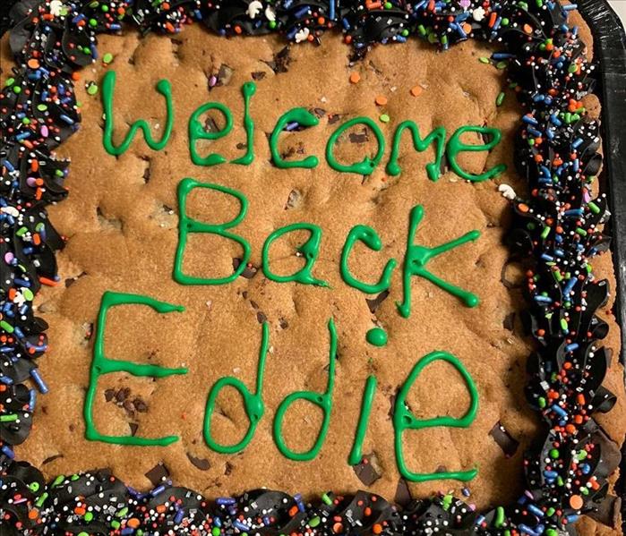 Photo of Cookie Cake that says "Welcome back Eddie"